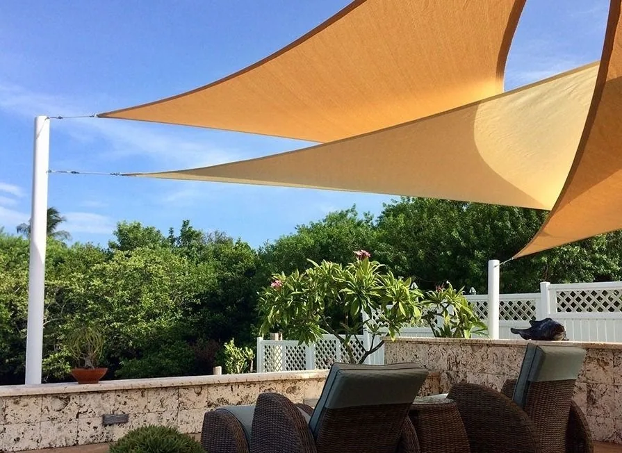 Orange and cream sails shading a garden seating area