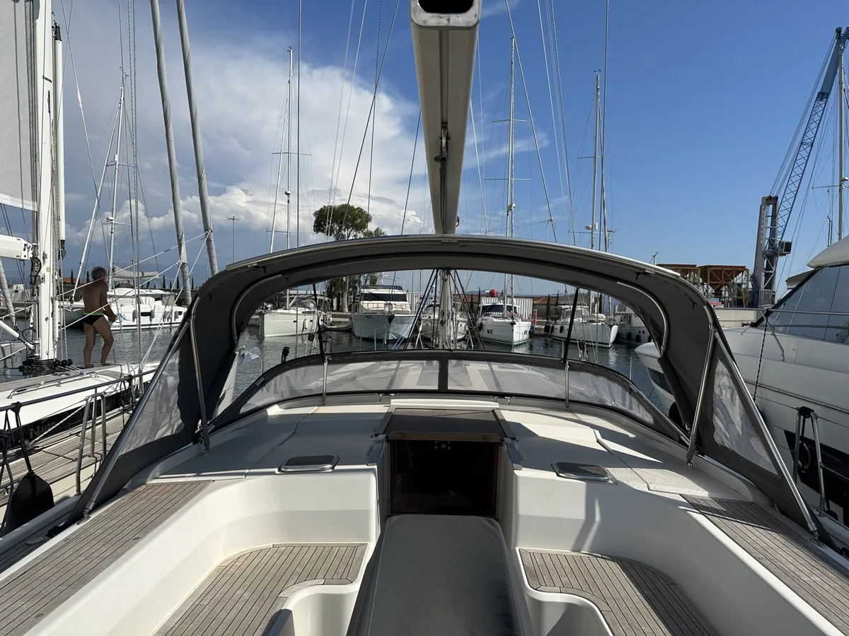 Grey sprayhood over the companionway, seen along the side deck