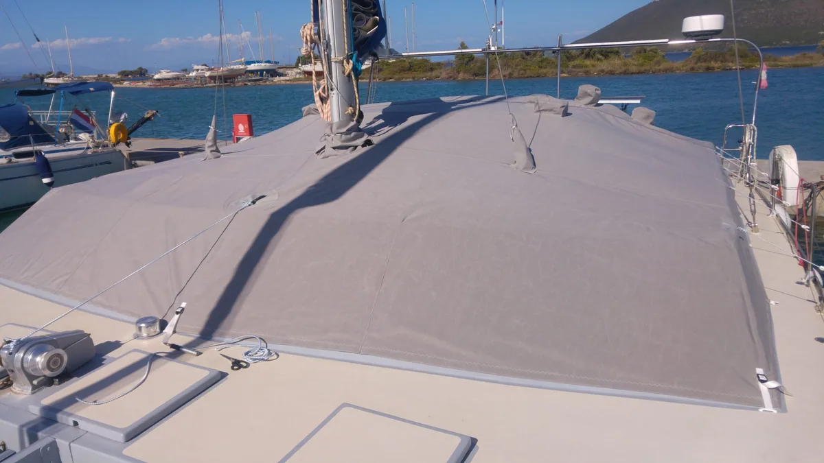 Grey full deck cover on a catamaran, photographed from the bow