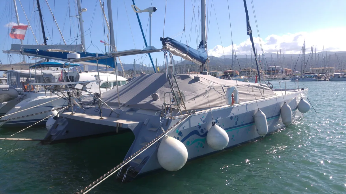 Catamaran at anchor with its deck and cockpit covers fitted