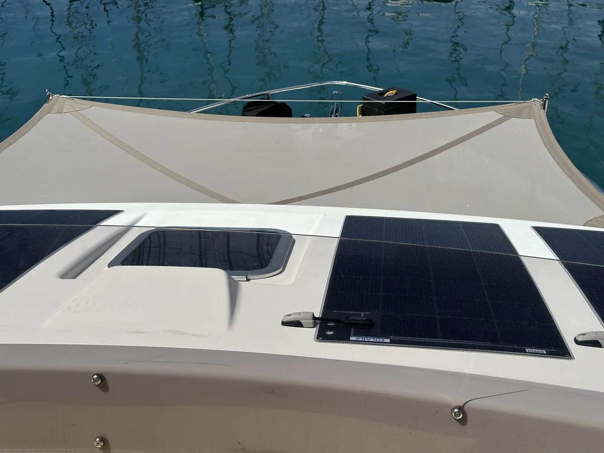 Awning shading the cockpit and solar panels of a motor yacht