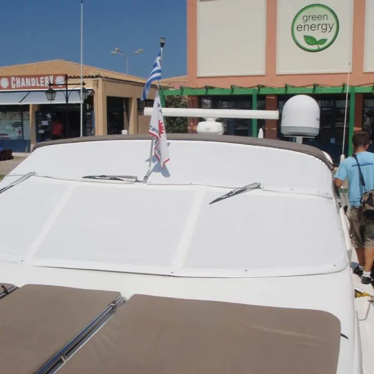 White windscreen cover on a motorboat outside a chandlery