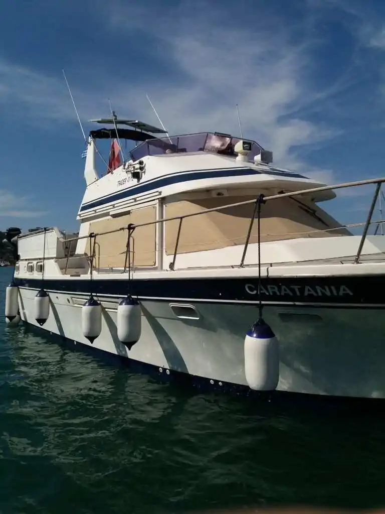Motor yacht under way with its bimini and window covers fitted