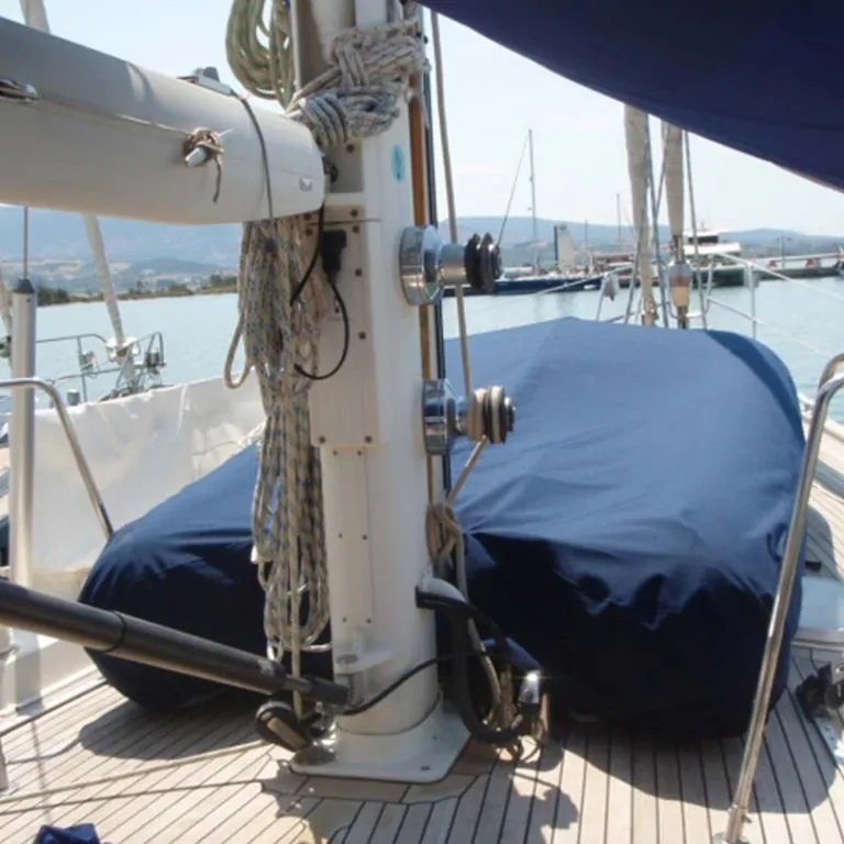 Blue cover over the boom and coachroof, seen past a stainless mast fitting