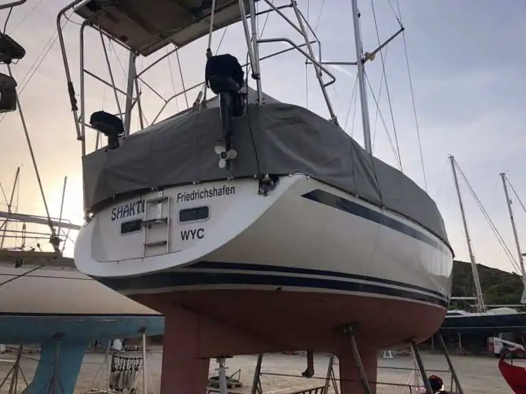 Grey cover over the stern and cockpit of a yacht standing in a boatyard cradle