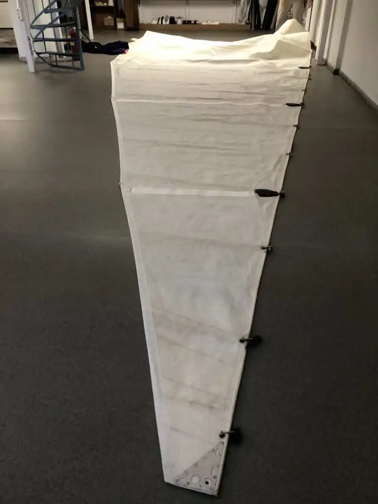 A long white canvas panel laid out down the workshop floor
