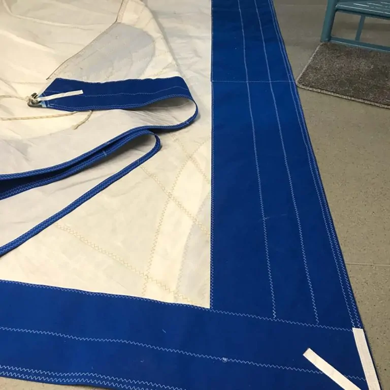 Blue and white canvas with its webbing straps laid out ready to sew