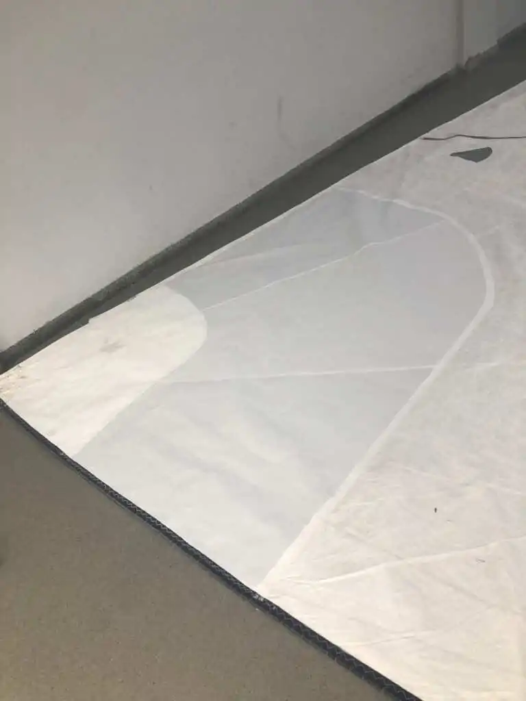 Cut panel laid flat against the wall of the workshop